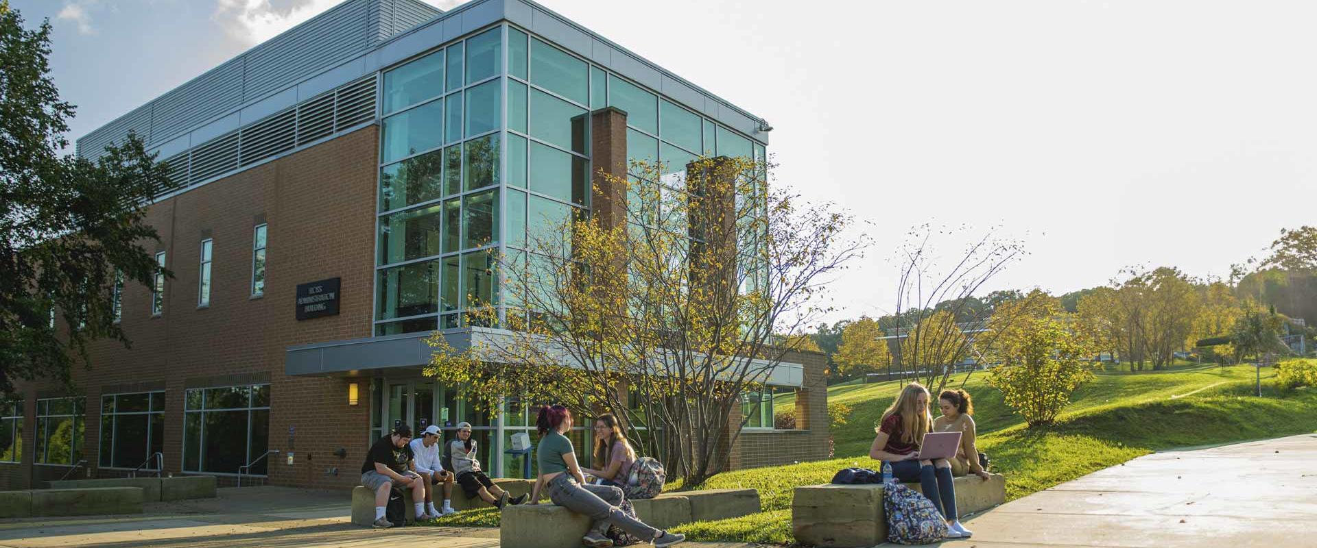 students visit while seated outside at Penn State Beaver